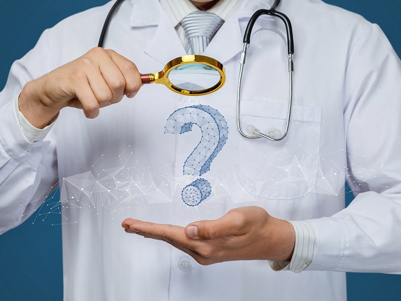 A physician holding a magnifying glass over a question mark symbolizing clinical decision support.