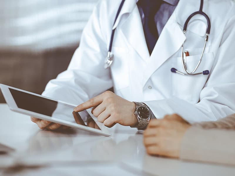 A physician reviewing a care plan with a patient, ensuring care gaps are closed.