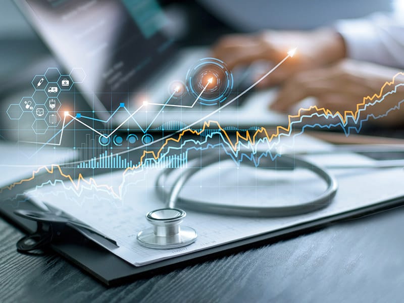 Population health management representation.Graphs and a doctor analyzing medical data on laptop.