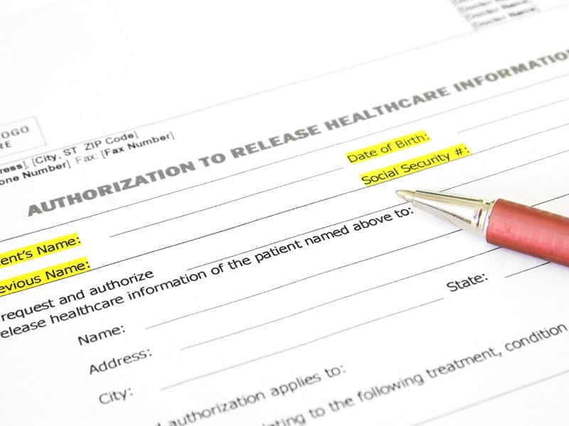 Health information release of information form with a pen on top.