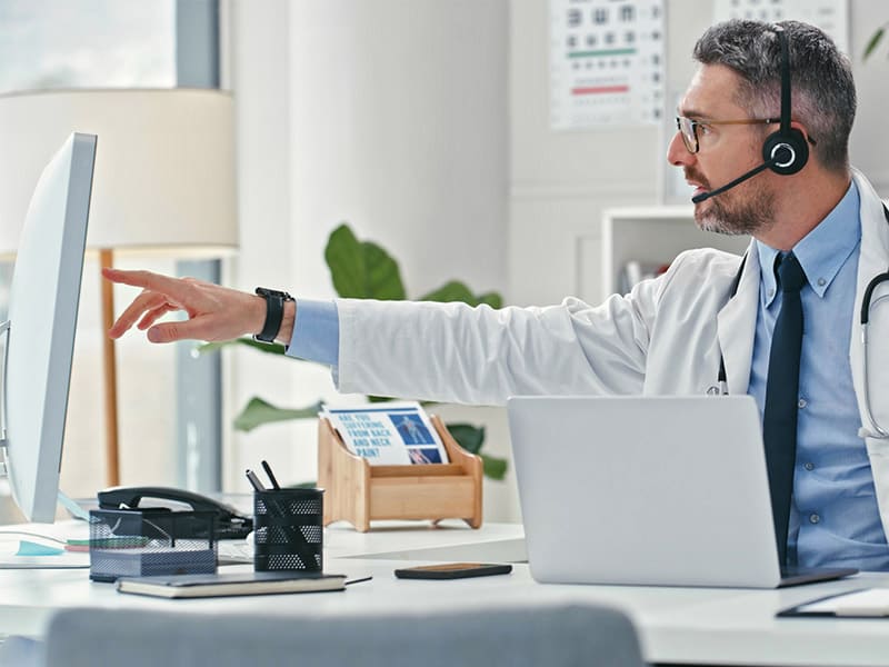 A-male-physician-using-multiple-systems-to-view-medical-information. A-male-physician-using-multiple-systems-to-view-medical-information.