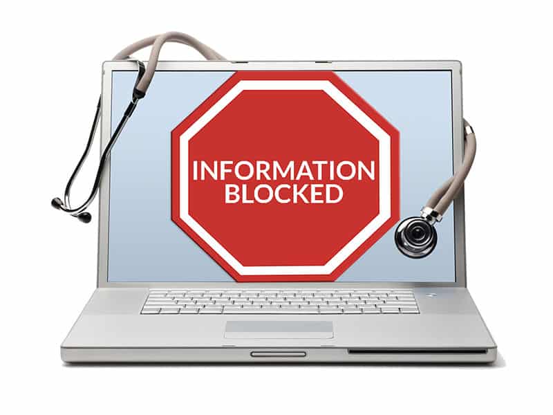 Information Blocked sign on a laptop representing OIG penalties, information blocking, and interoperability.