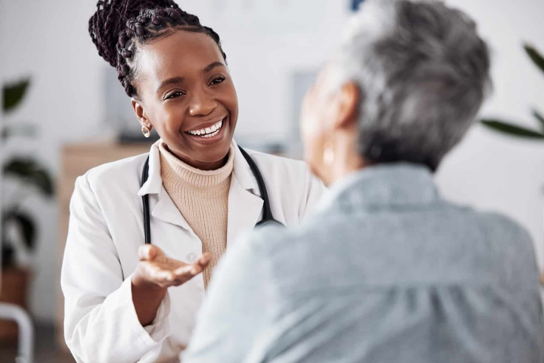 A father holding his daughter during a telehealth visit with a doctor.